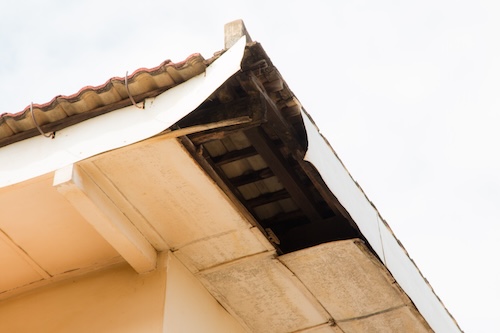 close up of broken roof corner where water can enter into the attic